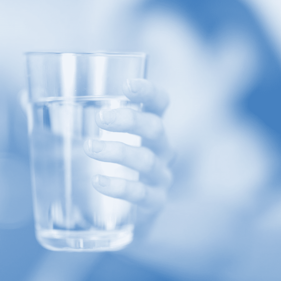 A woman holding a glass of water