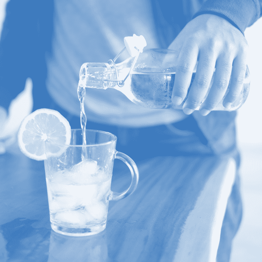 A person pouring water into a glass