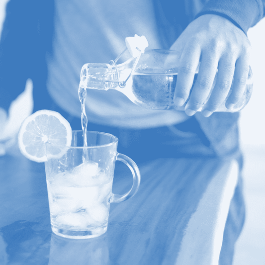 A person pouring water into a glass