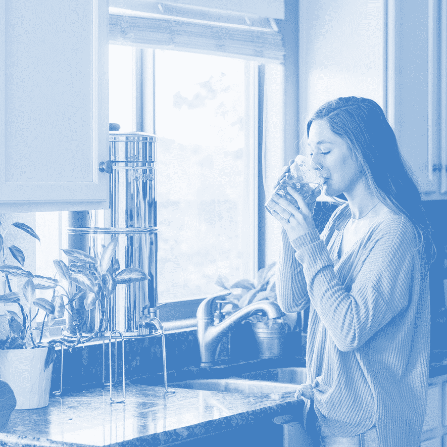 Girl drinking water from a gravity water filter